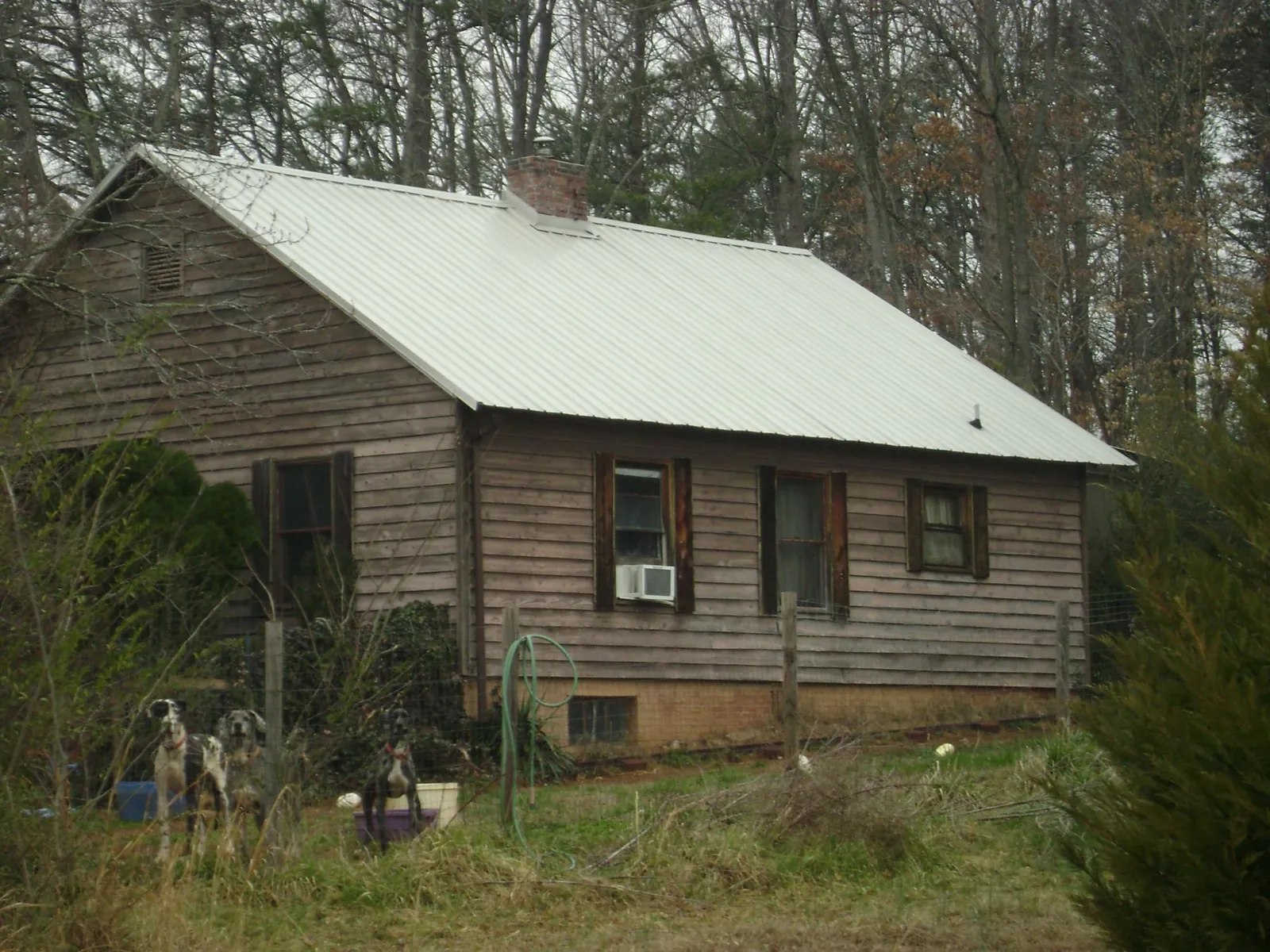 White metal roof on an old wood sided farmhouse, from a Metal Roof Installation job in Tallapoosa